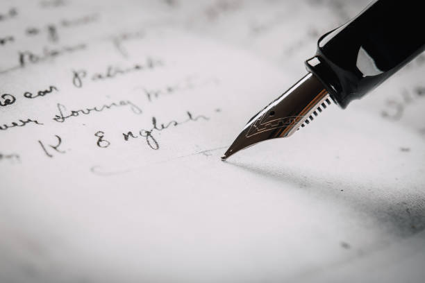 istock fountain pen on paper with ink text closeup 1194908031