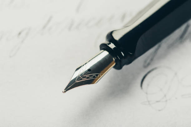 istock fountain pen on paper with ink text closeup 1194908037