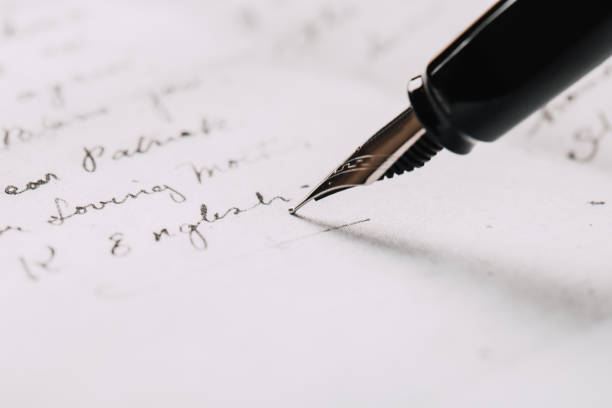 istock fountain pen on paper with ink text closeup 1194908257