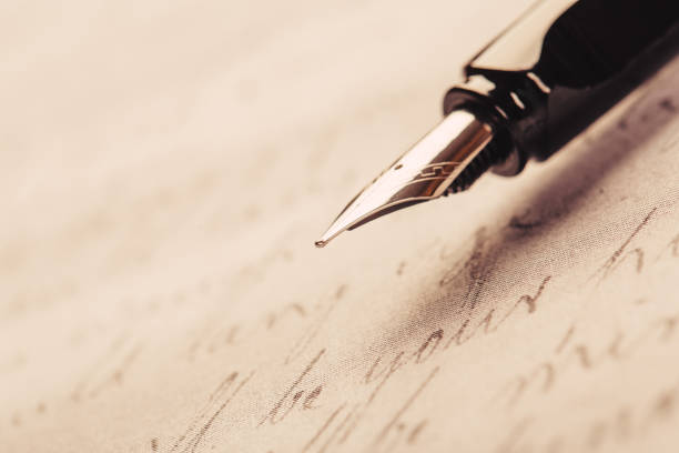 istock fountain pen on paper with ink text closeup 1194908270