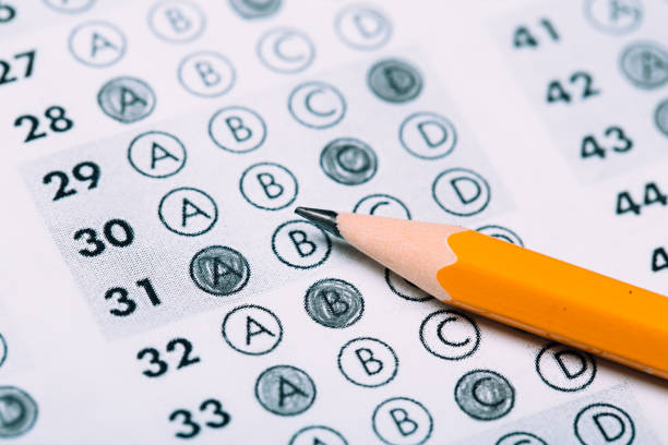 istock testing in exercise and exam paper. computer sheet with pencil in school test room, education concept 1194908276