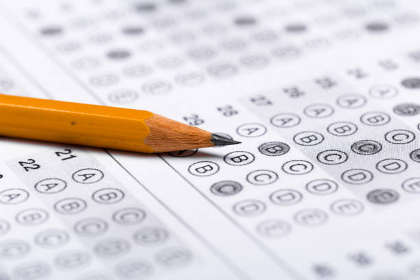 istock testing in exercise and exam paper. computer sheet with pencil in school test room, education concept 1194908320