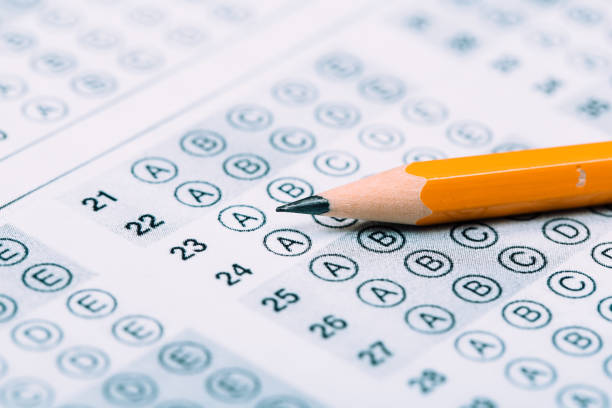 istock testing in exercise and exam paper. computer sheet with pencil in school test room, education concept 1194908344