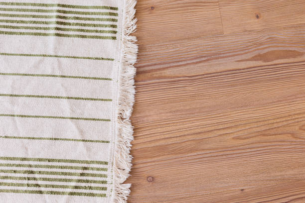 istock handmade light striped carpet on wooden floor 1194908391