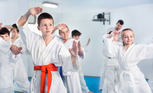 istock Children trying martial moves in karate class 1194908701