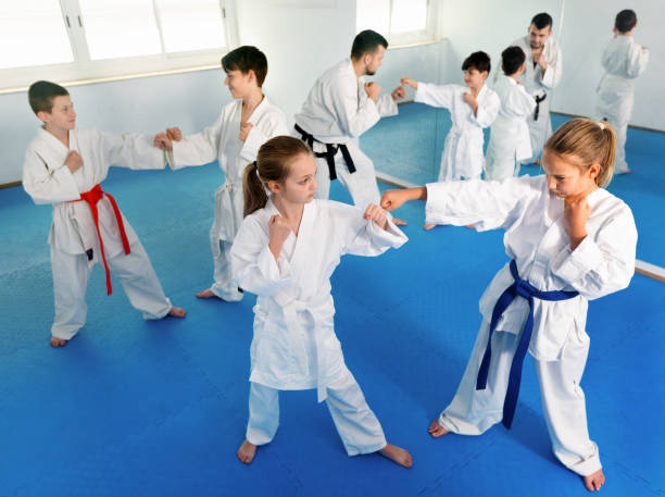 istock Teenagers practicing new karate moves in pairs in class 1194908704