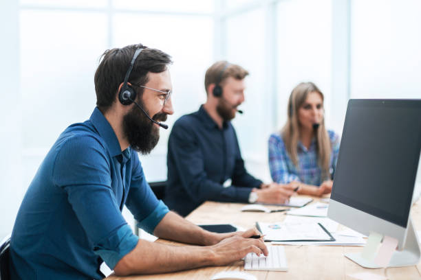 istock close up. business man in a headset working on a computer 1194910231