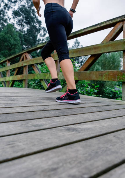 istock Woman running through an urban park 1194913454