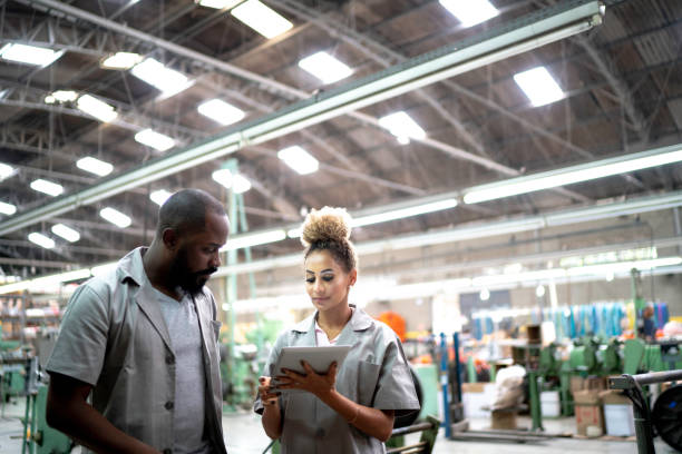 istock Coworkers using digital tablet in a factory 1194915568
