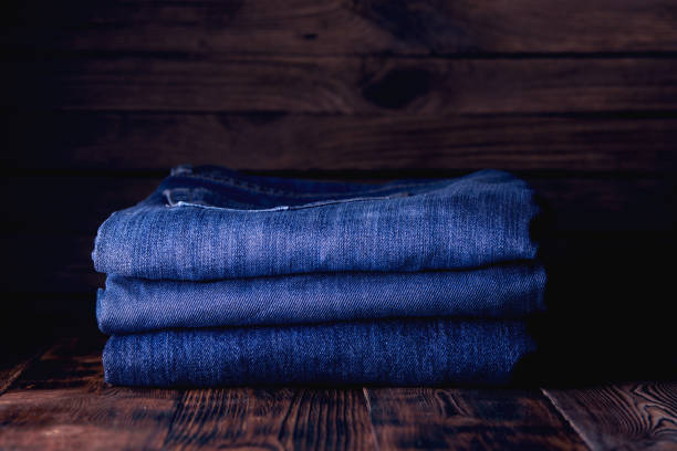 istock stack of jeans on wooden background 1194916829
