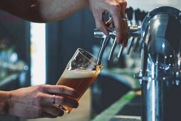 istock bartender hand at beer tap pouring a draught beer in glass serving in a restaurant or pub 1194916952