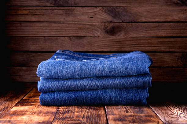 istock stack of jeans on wooden background 1194916955