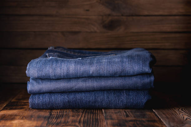 istock stack of jeans on wooden background 1194916976