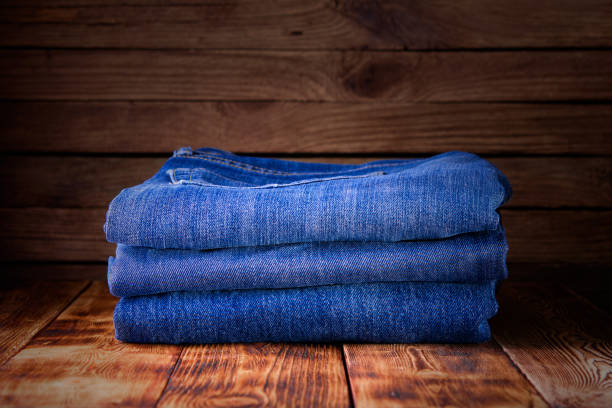 istock stack of jeans on wooden background 1194917029