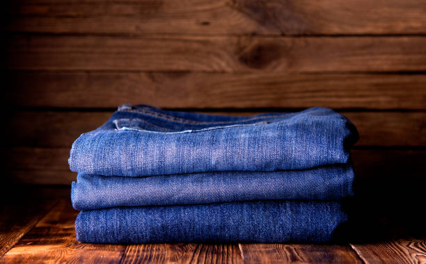 istock stack of jeans on wooden background 1194918217