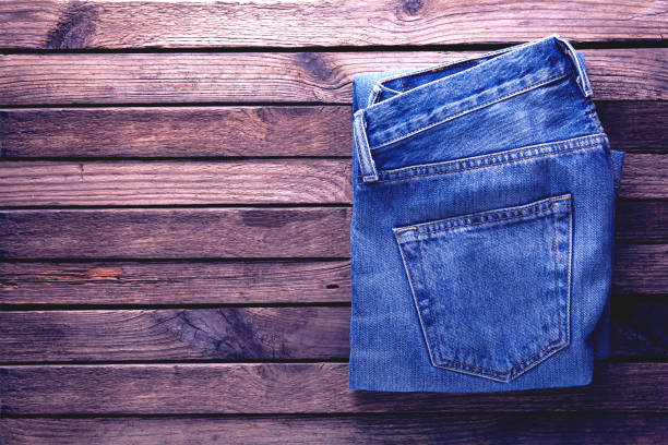 istock jeans on old wooden background 1194918284