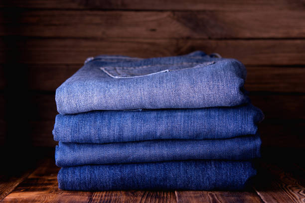 istock stack of jeans on wooden background 1194918339