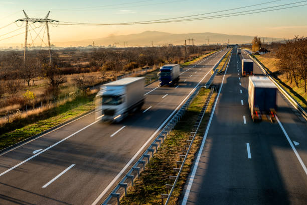 istock Fast blurred delivery trucks in high speed driving on a highway 1194918446