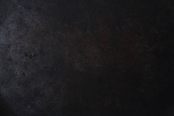 gloomy black painted metal surface. industrial background