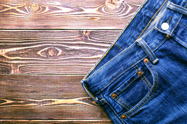 istock jeans on old wooden background 1194918502