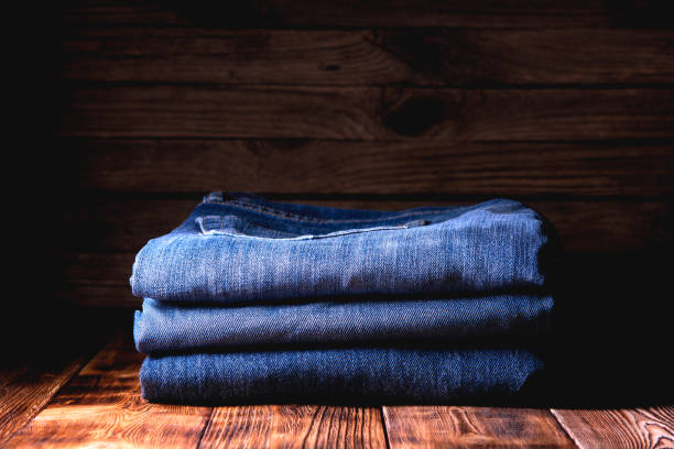 istock stack of jeans on wooden background 1194918578