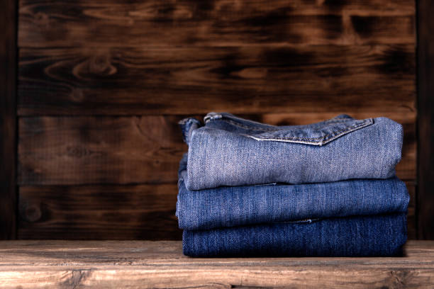 istock stack of jeans on wooden background 1194919123