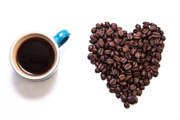 istock Heart shape created with coffee beans and a mug 1194921310
