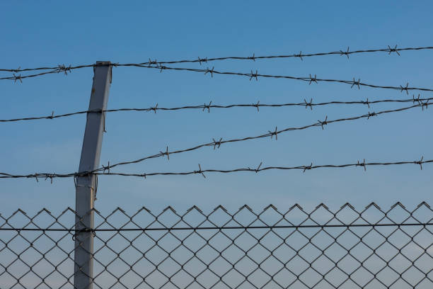istock Metal fence with barbed wire. 1194921904
