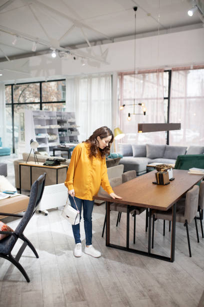 istock Long-haired pretty woman touching the table surface 1194922579