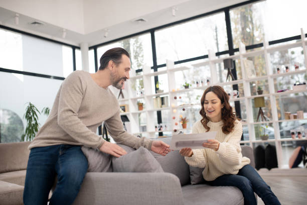 istock Woman in white sweater looking at the drawing 1194922617