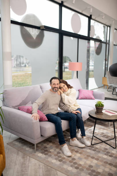 istock Couple sitting on the cosy beautiful sofa and feeling good 1194922648