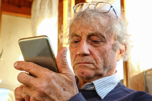istock Senior Reading from His Mobile Phone 1194922723