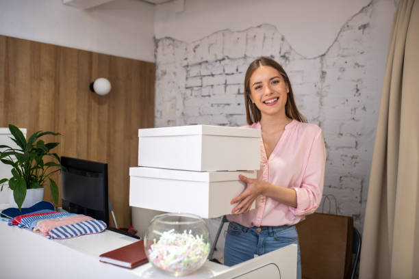 istock Smiling administrator holding boxes for delivery service 1194922858