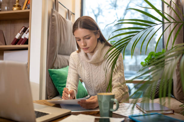 istock Concentrated woman working with an important document 1194922980