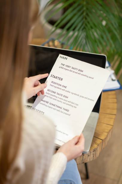 istock Long-haired woman working with the menu card 1194923013