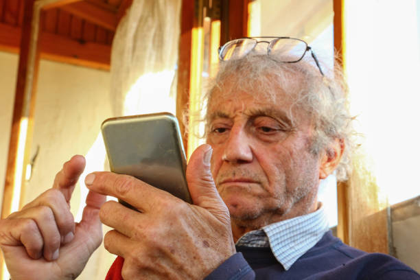 istock An Old Man About to Tap on The Screen 1194923825