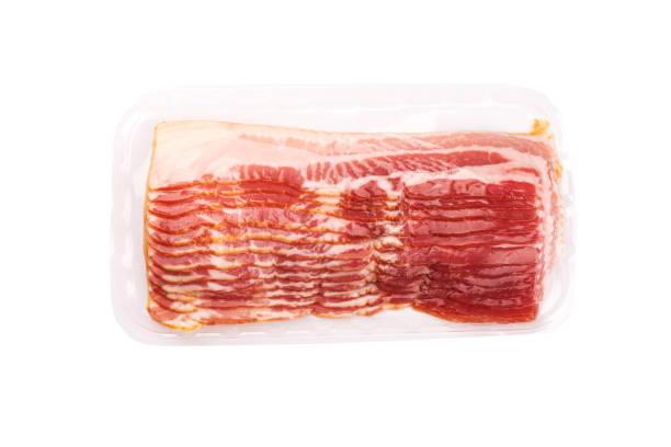 istock Vacuum packed bacon rashers isolated on white background. 1194924193