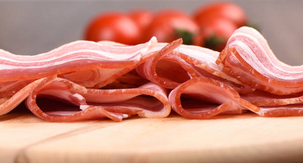 istock Macro shot. Rashers of bacon on a cutting board. Close up. 1194924213