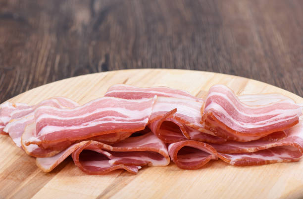istock Rashers of bacon on a cutting board. Close up. 1194924228