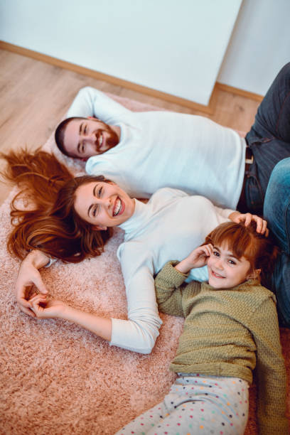 istock Happy Family Lying Down Together On The Floor 1194924295