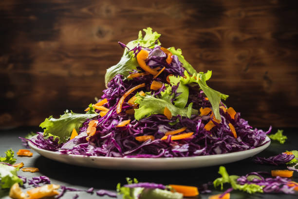 istock head lettuce bell pepper red cabbage salad casually scattered around a flat dish. wooden background. 1194925281