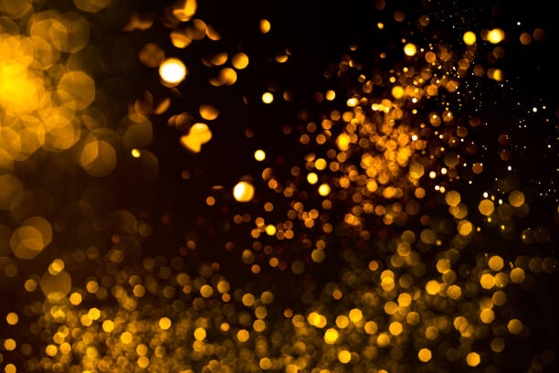 istock Golden abstract bokeh on black background. 1194925540