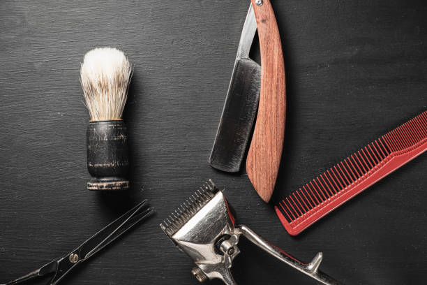 istock vintage barber tools dangerous razor hairdressing scissors old manual clipper comb shaving brush. old black background. 1194926264