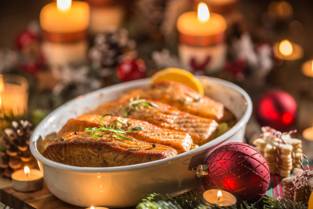 istock Christmas dinner from fish salmon in roasting dish with festive decoration advent wreath and candles. 1194926331