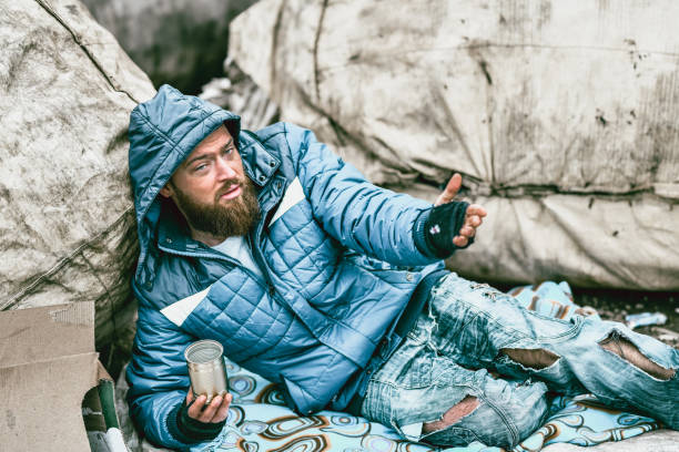istock Sad Male Beggar In The Streets Begging For Help 1194926714