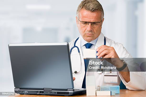 Mature Doctor Check Some Medicines Stock Photo - Download Image Now - Box - Container, Doctor, 50-59 Years