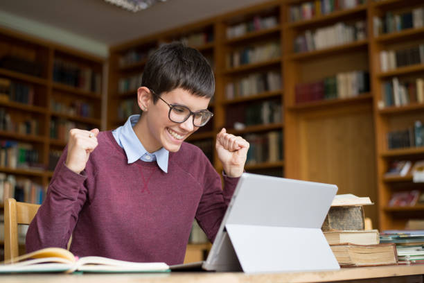 istock Young woman studying in the library 1194930206