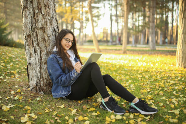 istock woman student working with tablet in university garden 1194931012