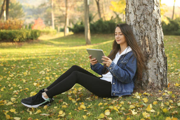 istock woman student working with tablet in university garden 1194931058