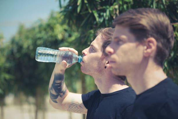 istock twin brothers drinking water 1194932129